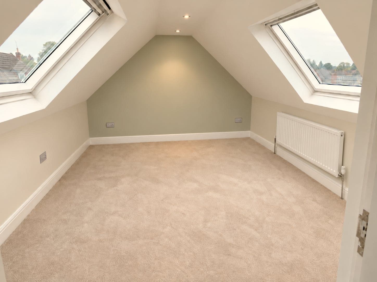 Loft room with twin roof windows and sage green feature wall, rooflight loft conversion in Barnet EN5
