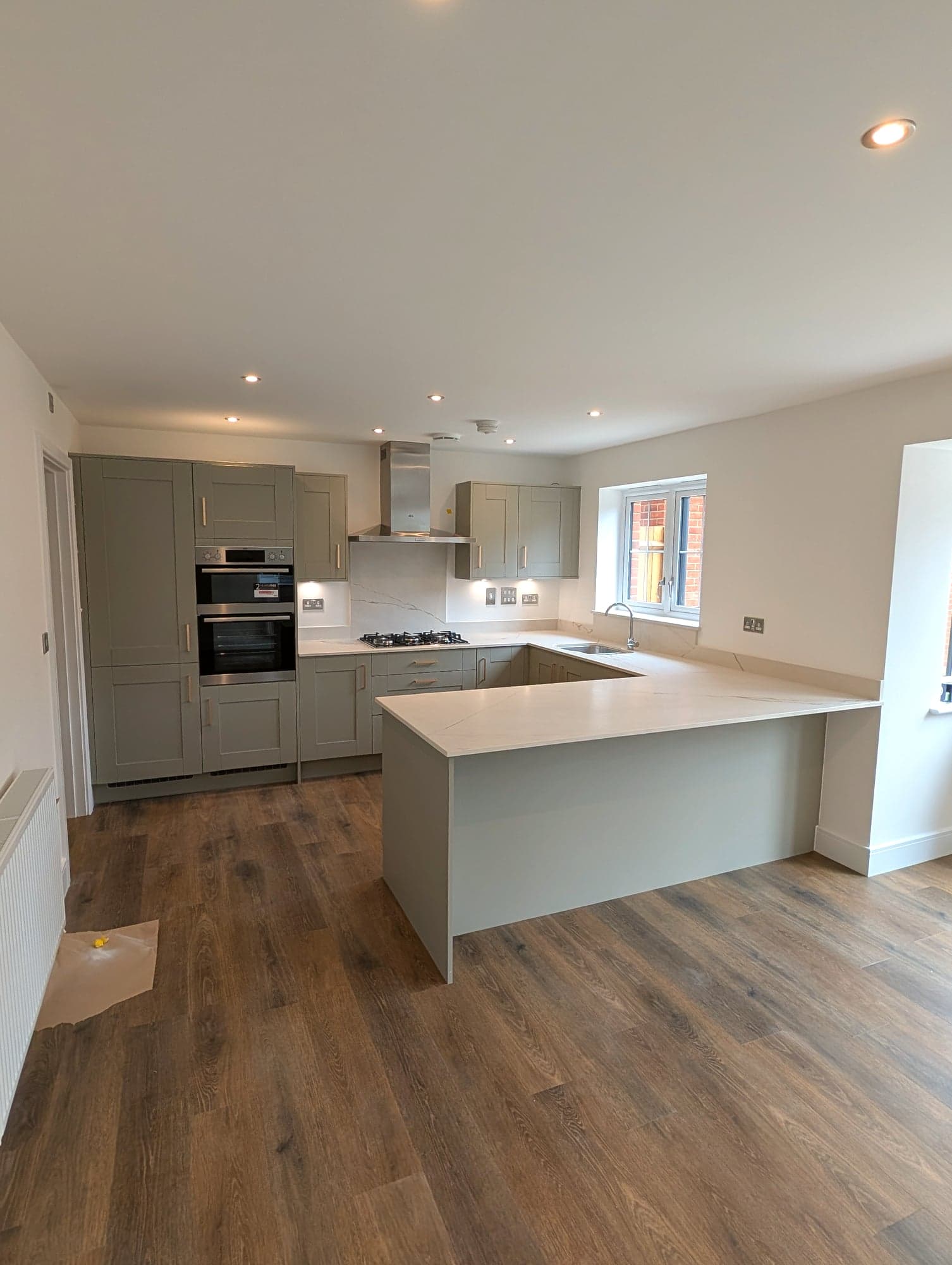 Sage green shaker kitchen renovation with waterfall island, Chiswick W4