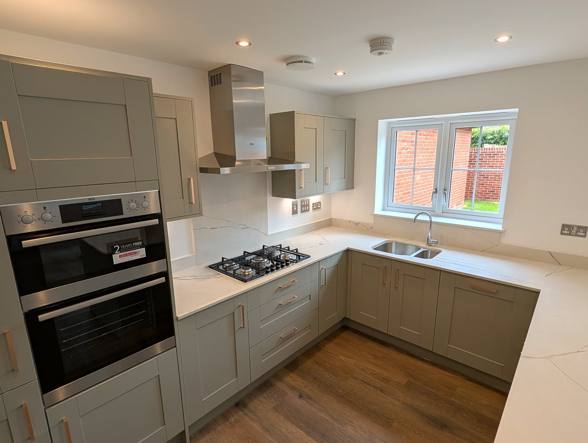 Built-in double oven, hob and sink run along the window wall, Chiswick W4