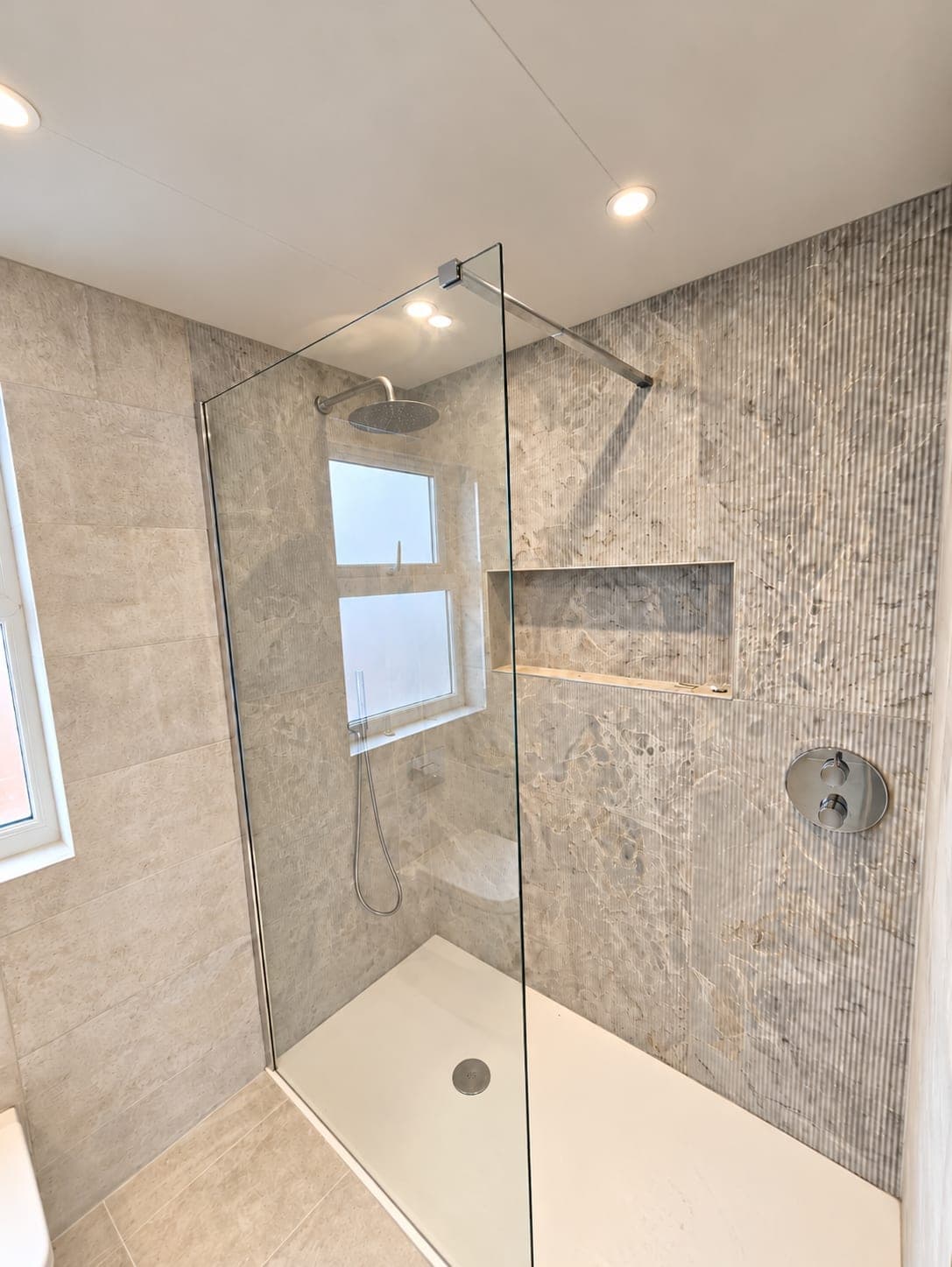 Walk-in shower with frameless screen, recessed niche and level stone-effect tray, St John's Wood NW8