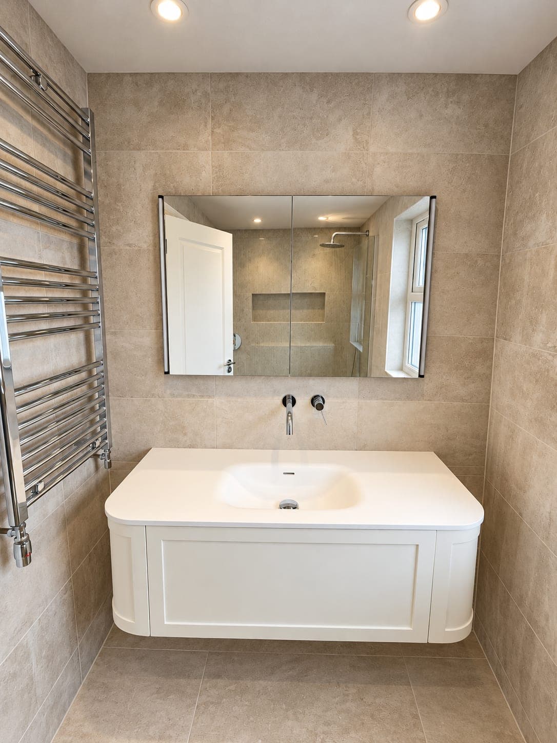 Curved vanity and mirrored cabinet with the chrome towel rail alongside, St John's Wood NW8