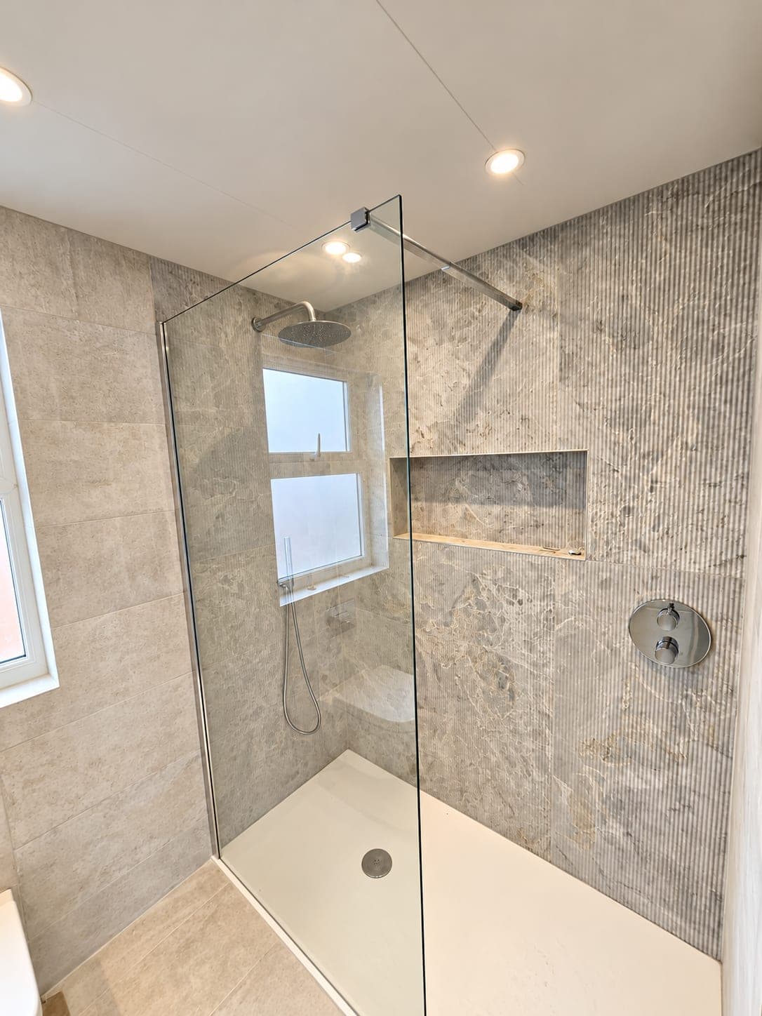 Shower enclosure with rainfall head and concealed valve under the window, St John's Wood NW8