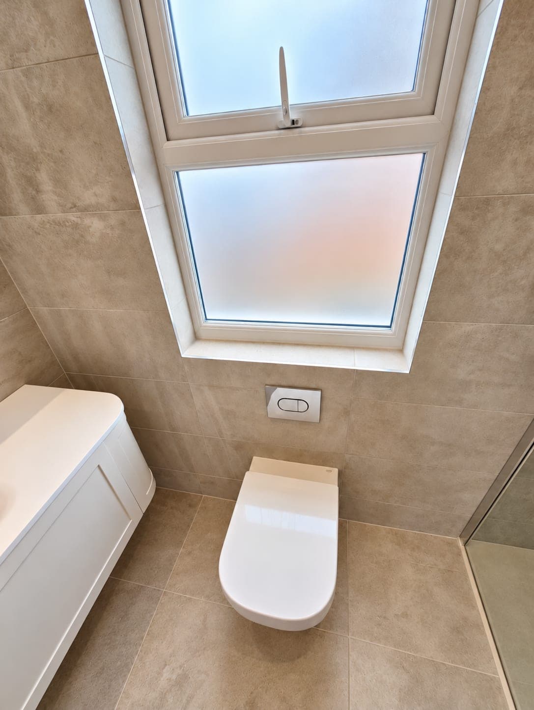 Wall-hung WC beneath the roof window with the vanity alongside, St John's Wood NW8
