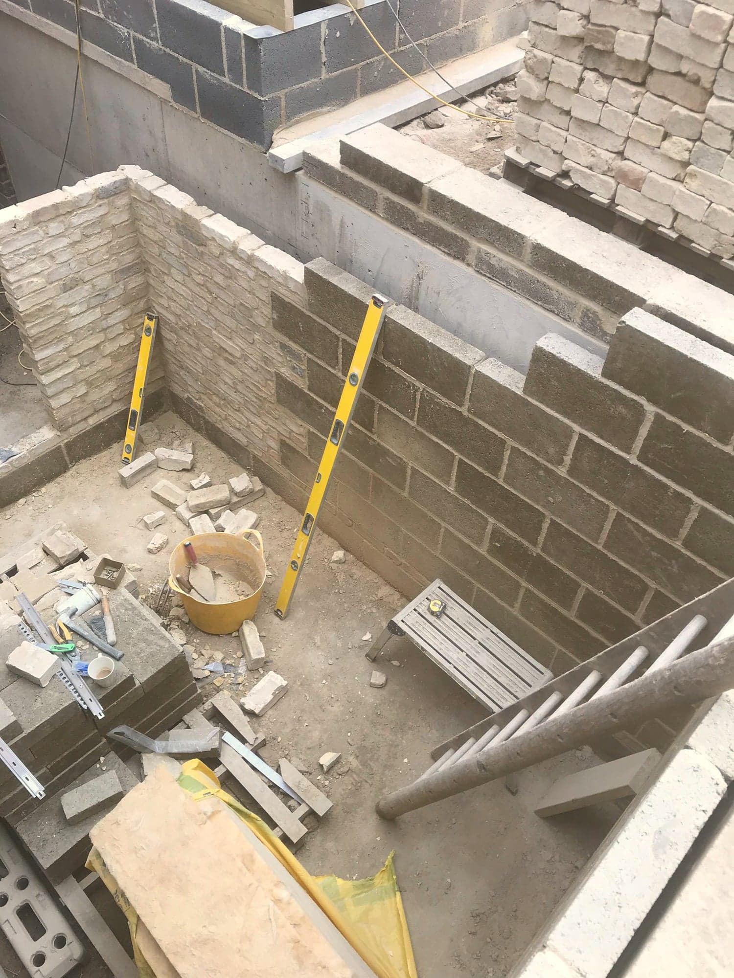 Blockwork and stone facing going up around the new lightwell, Kensington W8