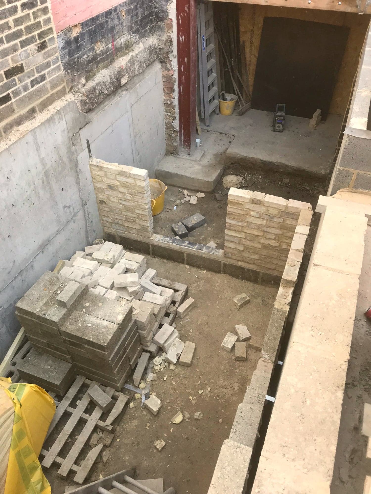 Excavated courtyard with stone cut and stacked ready to lay, Kensington W8