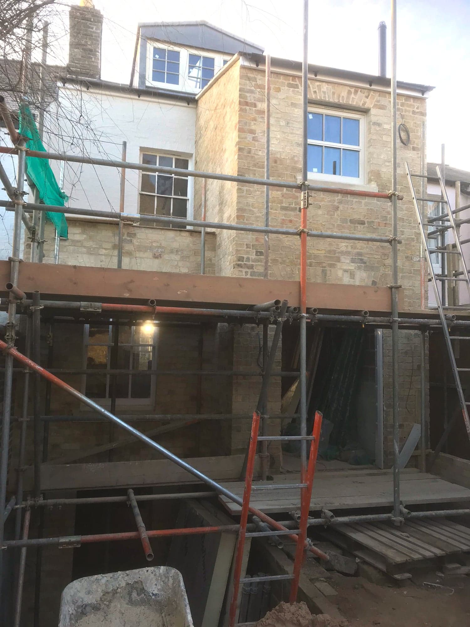 Rear elevation under scaffold with the new stonework rising, Kensington W8