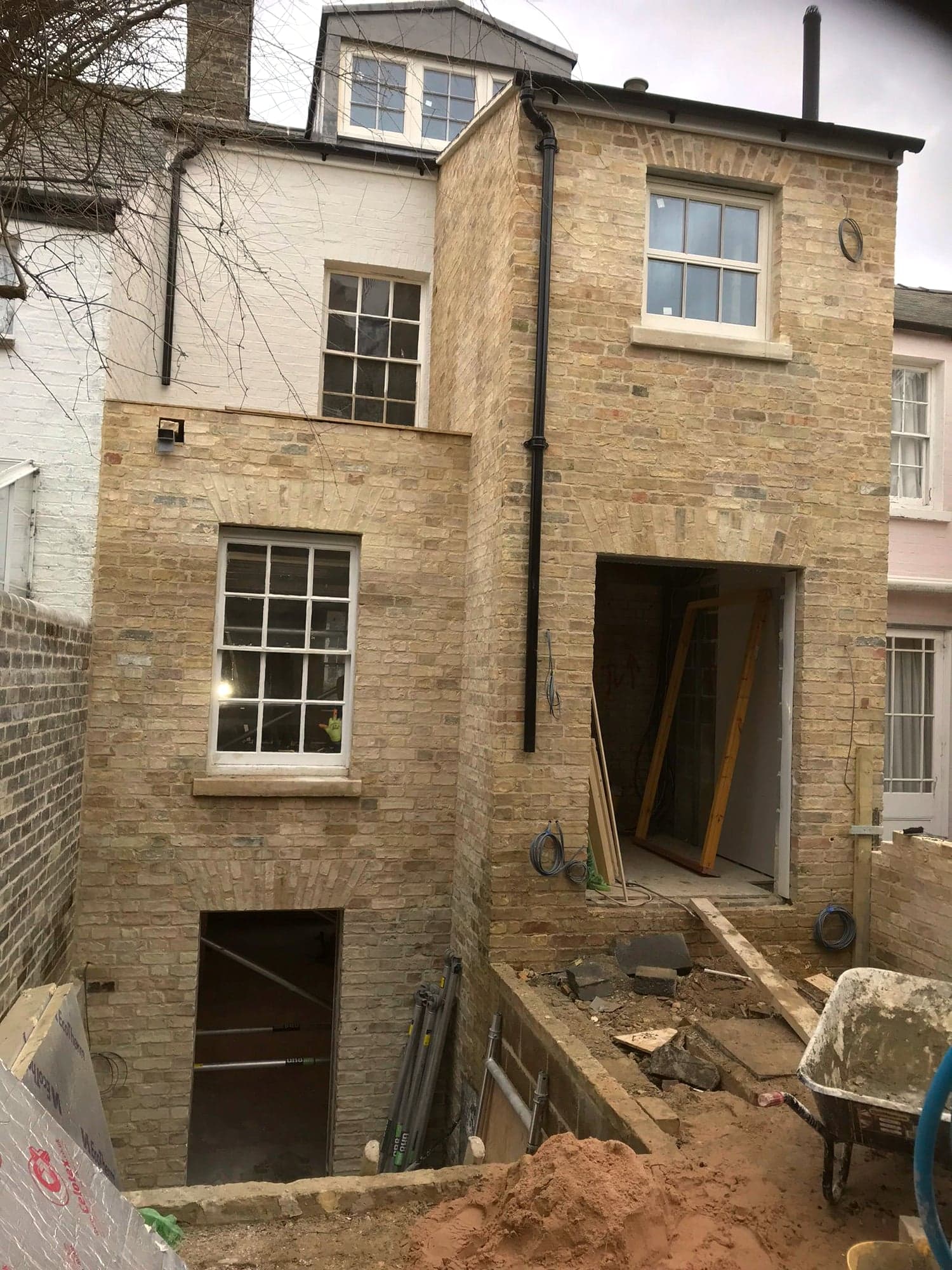 Rear elevation during the build, stonework complete and openings awaiting frames, Kensington W8