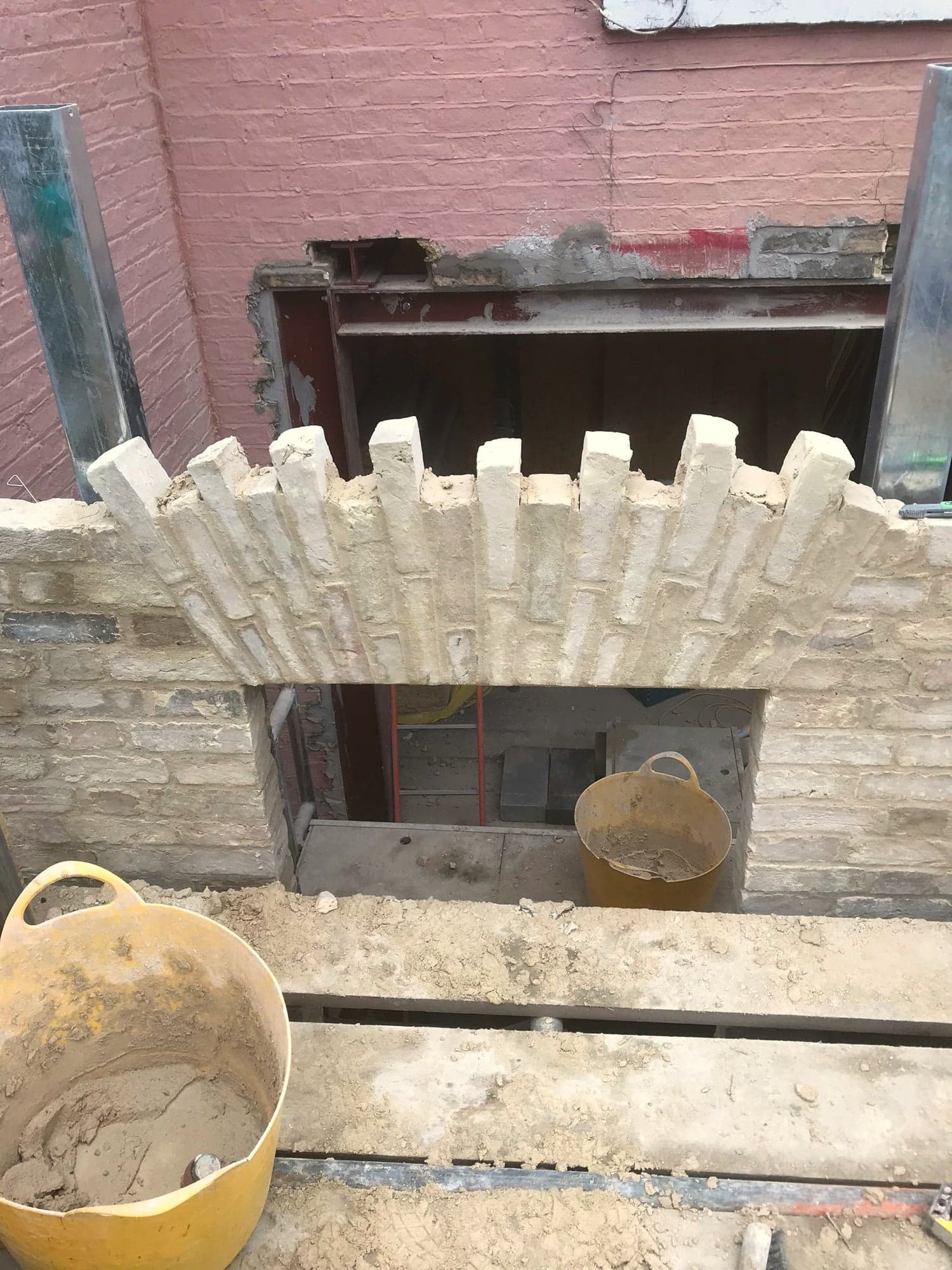 Brick arch formed over the lower ground opening before facing, Kensington W8