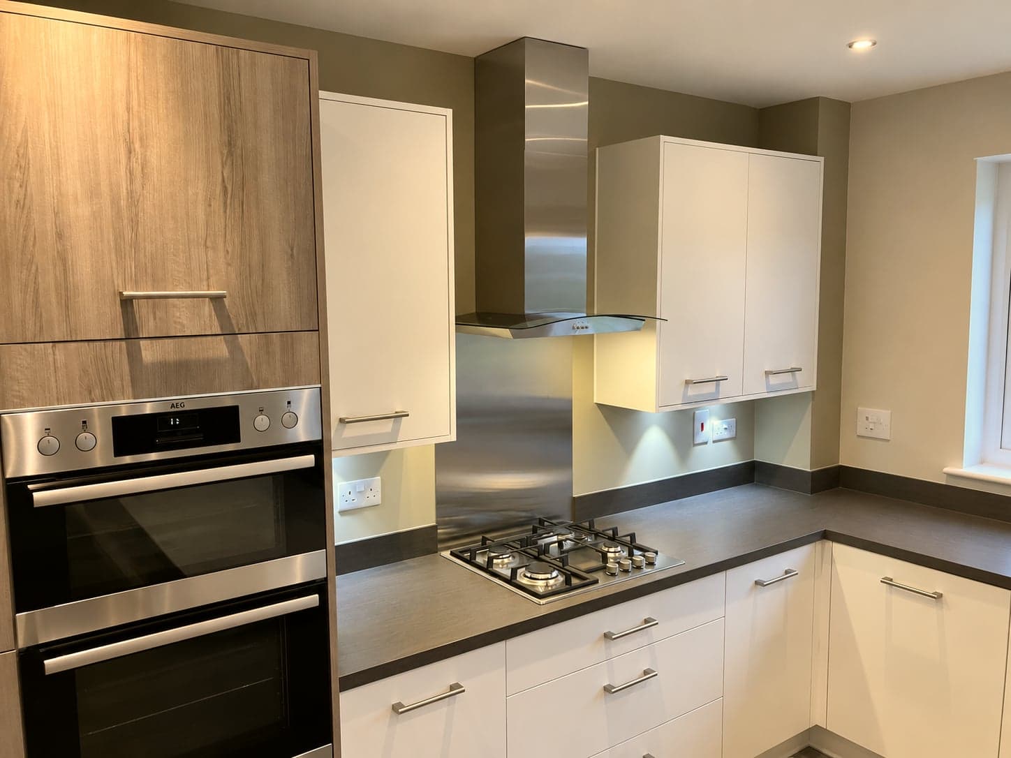 Built-in double oven in the oak-effect housing beside the hob and extractor, St Albans AL1