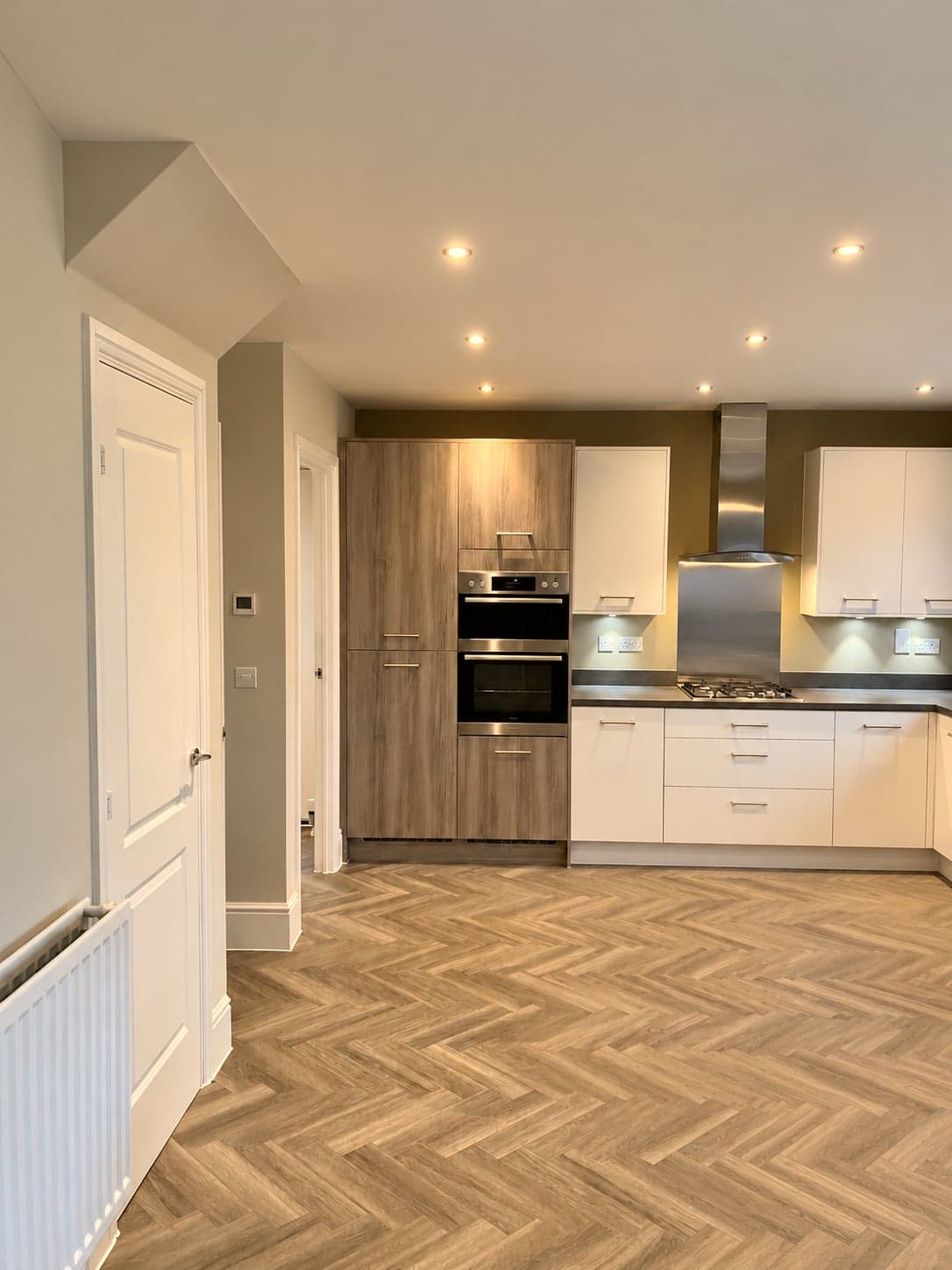 Kitchen seen from the hall across the herringbone floor, St Albans AL1