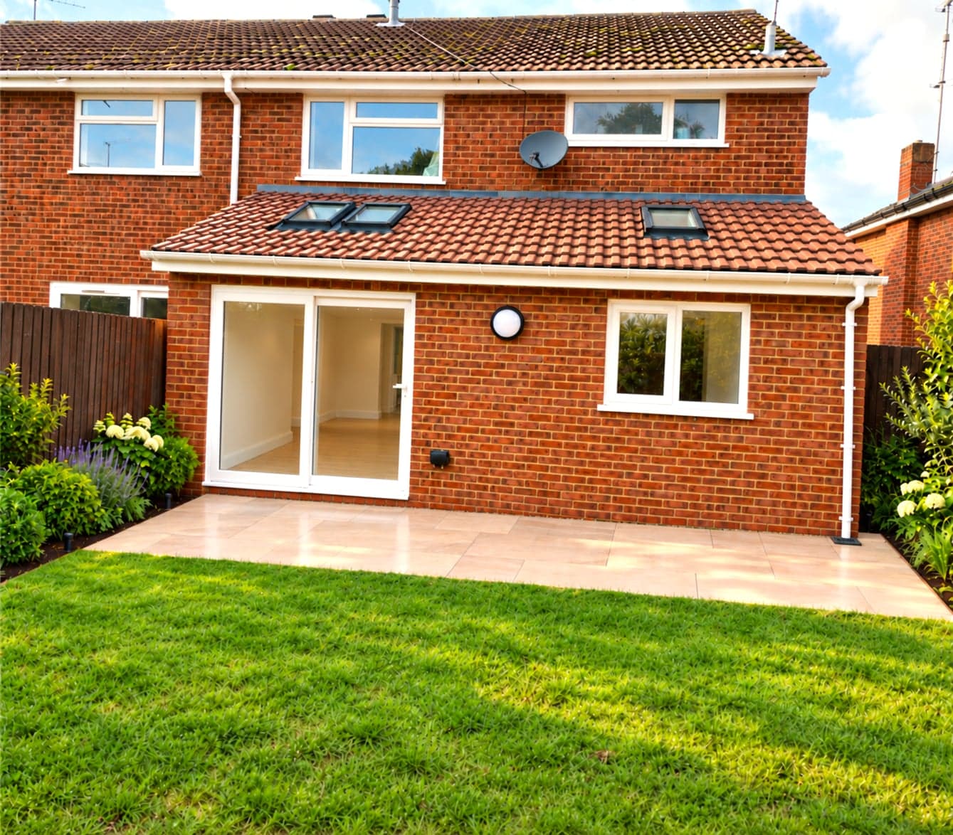 Finished brick rear extension with sliding doors and roof skylights, Borehamwood WD6