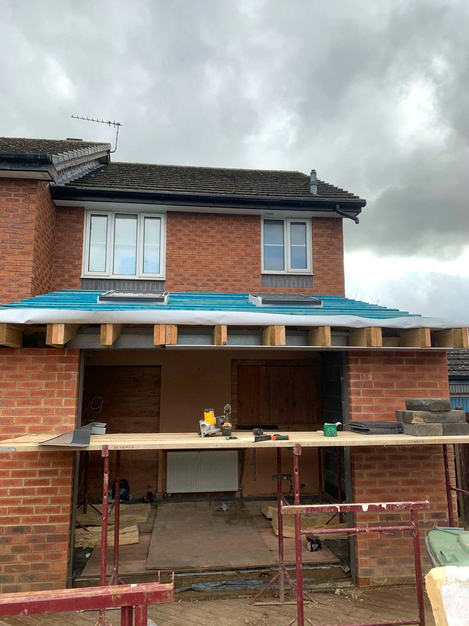 Flat roof decked and covered while the rear wall is still propped, Borehamwood WD6