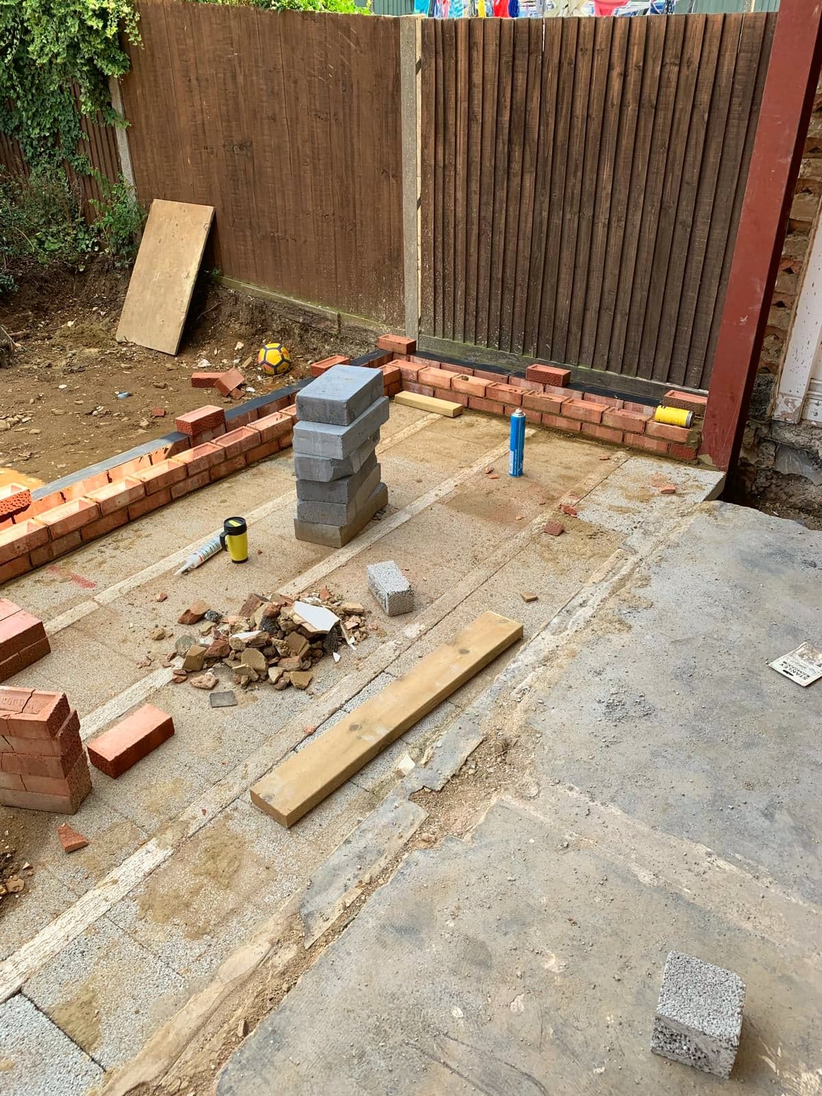 Foundations and first course of brickwork set out on the new slab, Borehamwood WD6