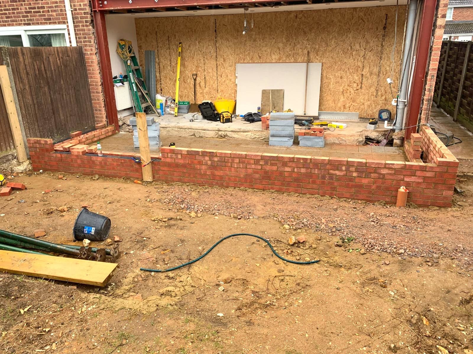 Extension walls at mid height with the steel beam already in over the opening, Borehamwood WD6