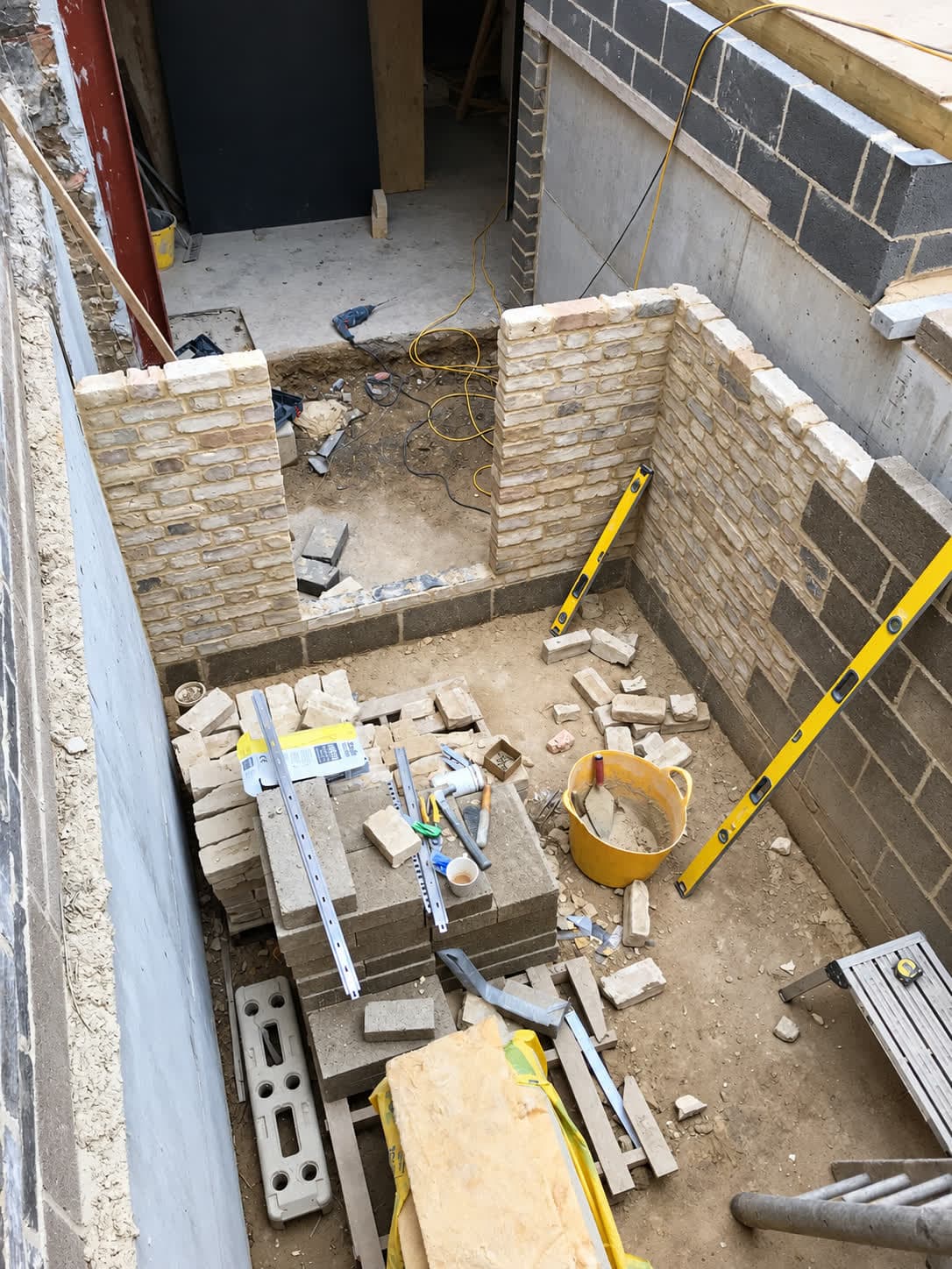 London stock brick outer leaf and blockwork inner leaf rising on a rear extension, London
