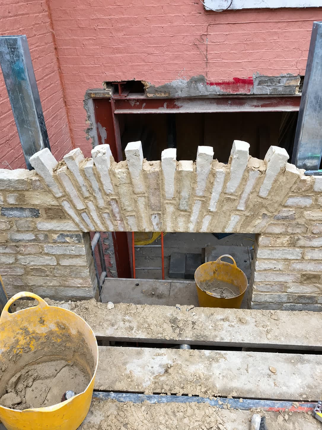 Stock brick soldier arch formed over a new opening in an existing wall, London