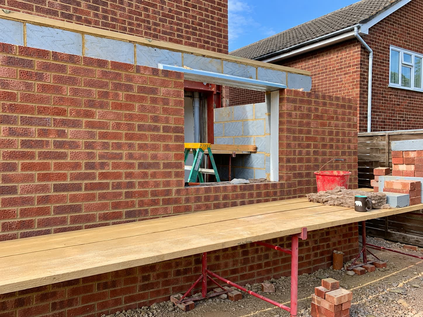 Red brick side wall built up with a window opening and lintel, London