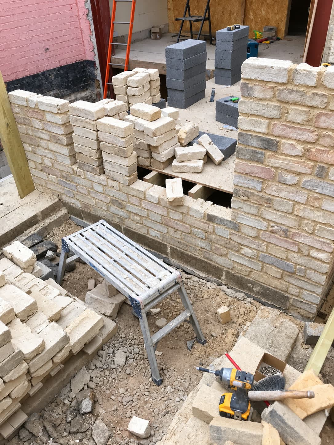 New stock brick wall with openings being formed, London