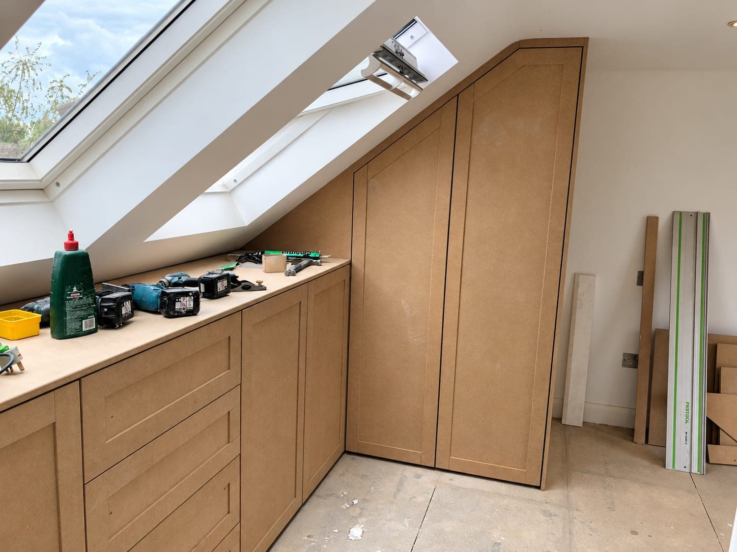 Bespoke drawers and cupboards built into a loft eaves slope, London