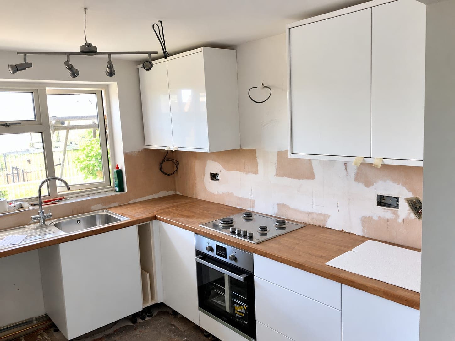 Kitchen units and timber worktop fitted around the oven and hob, London
