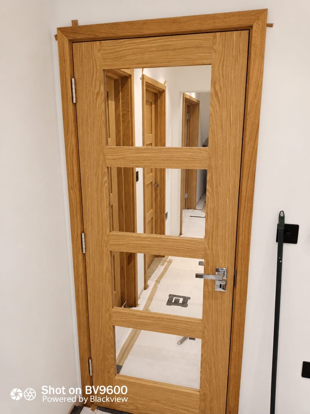 Glazed oak door hung in a new frame with hinges fitted, London
