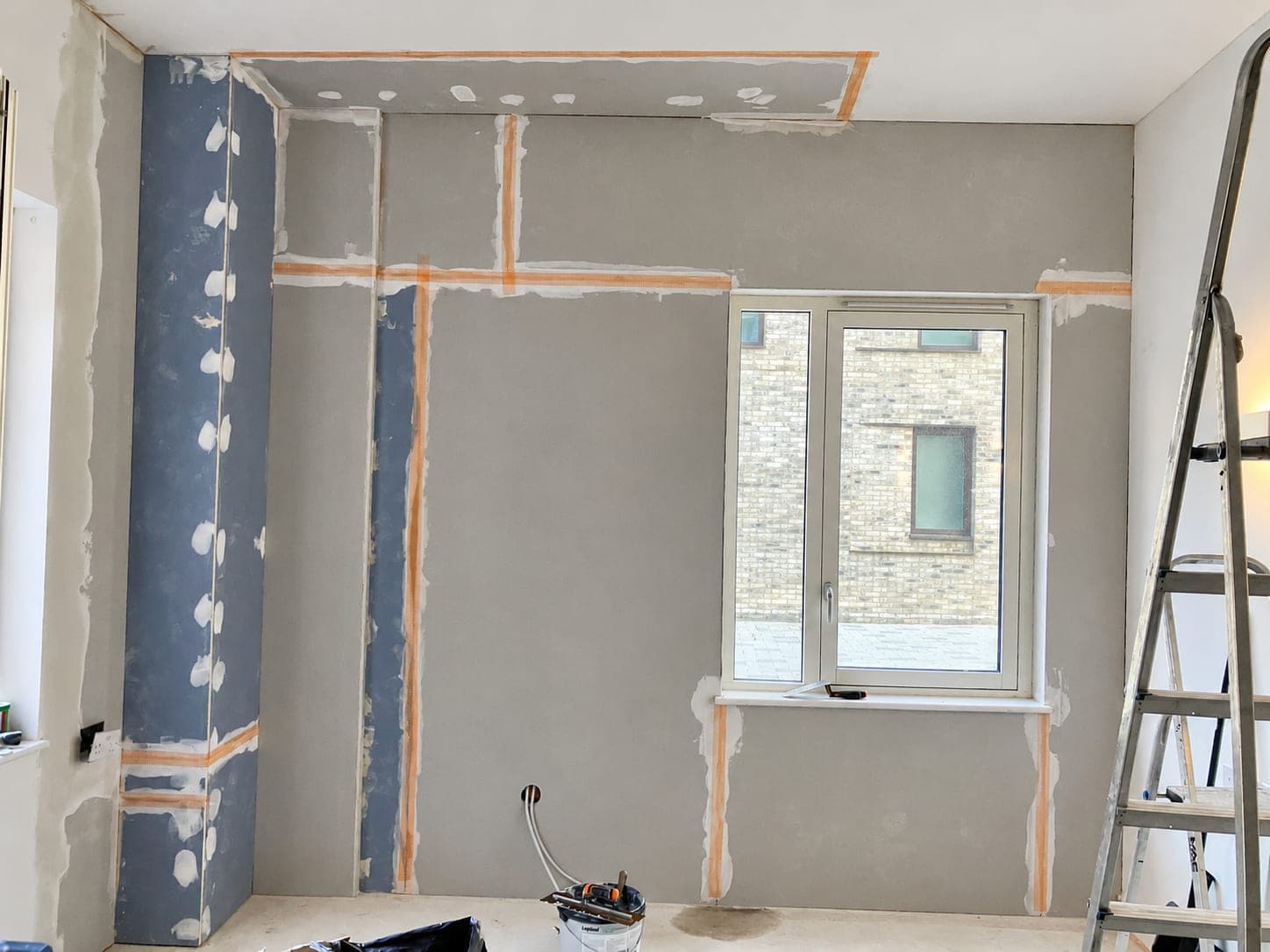 Plasterboard joints taped and filled ready for skimming, London