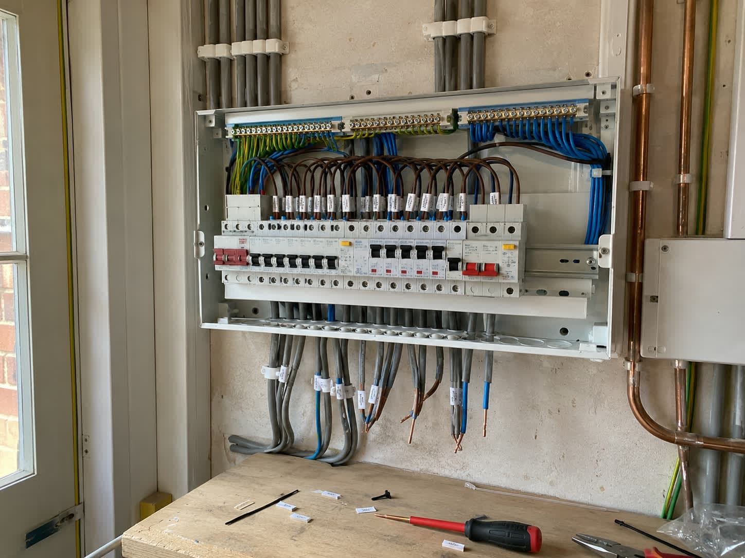 Large new consumer unit wired in with labelled circuits and RCBOs during a full rewire, London