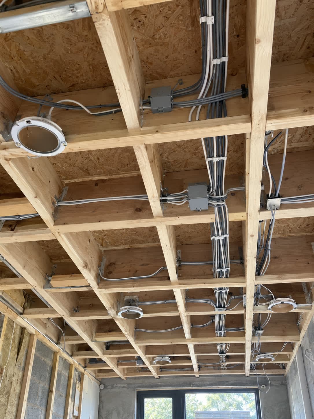 Lighting cables clipped to ceiling joists with junction boxes and downlight positions, London