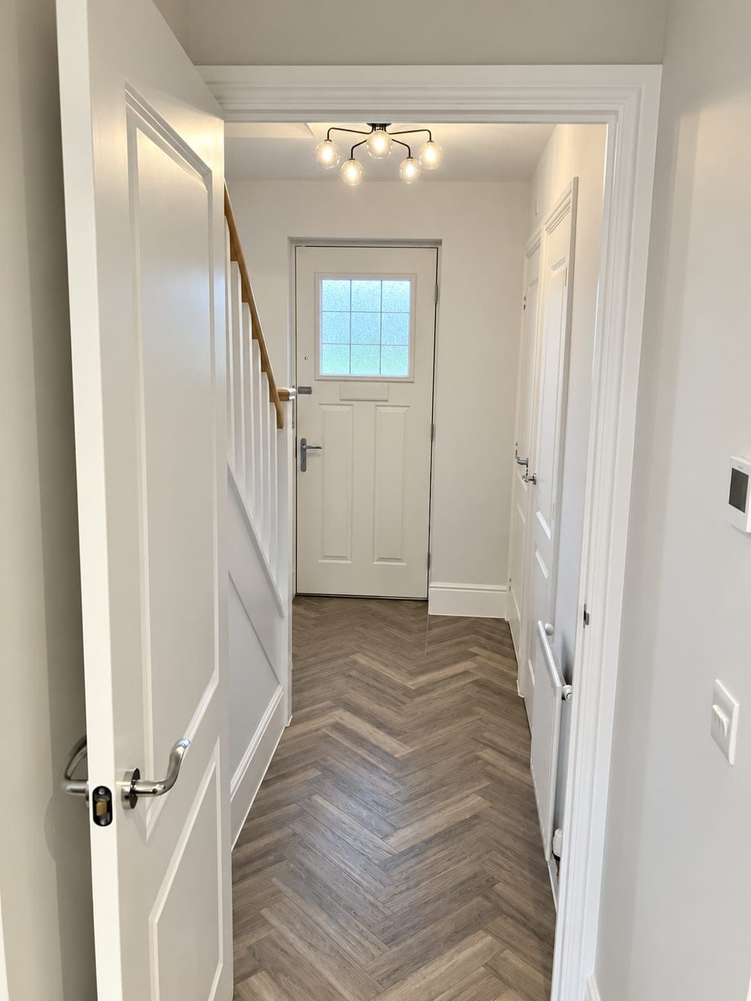 Herringbone flooring laid along a hallway, London