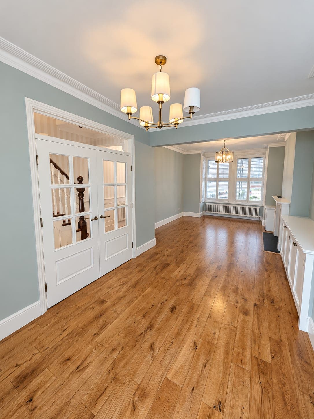 Oak flooring in a reception room with glazed internal doors, London