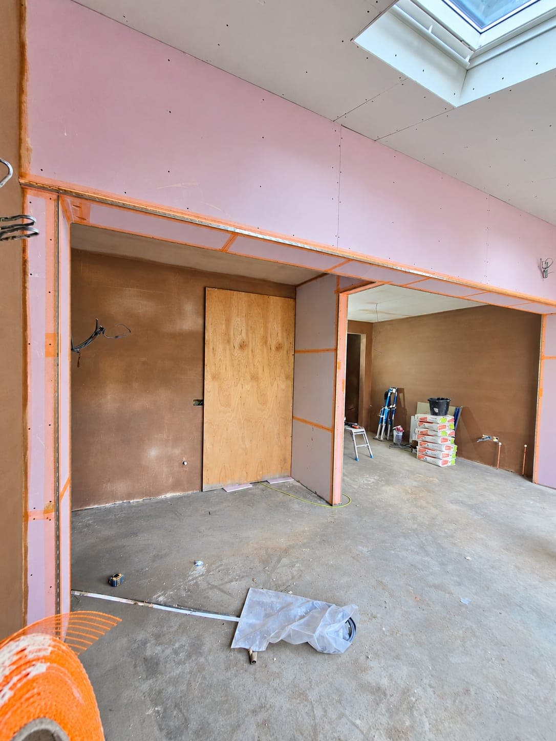 Plasterboard taped and scrimmed at the joints before skimming, London