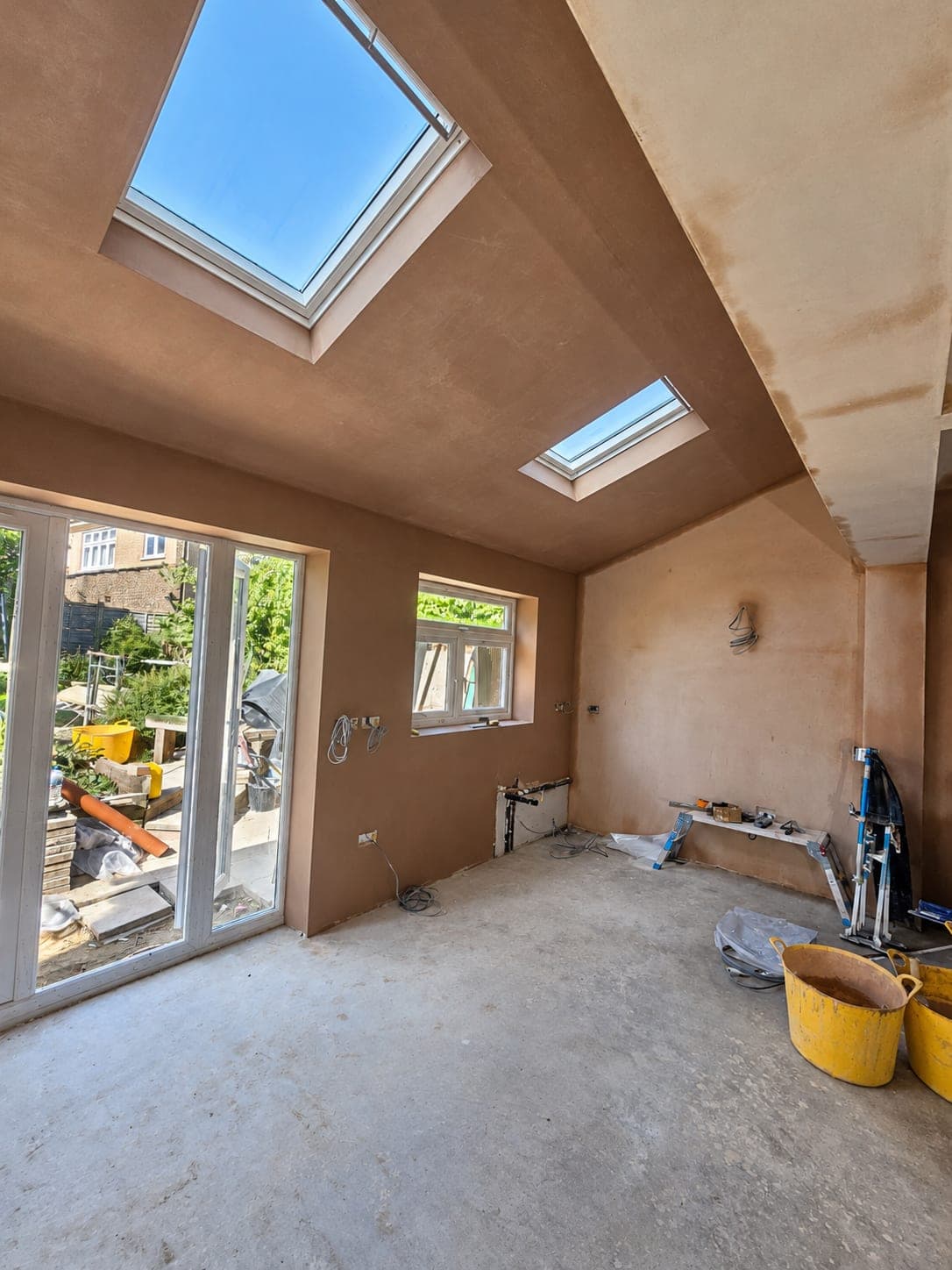 Open-plan room skimmed throughout with rooflights above, London