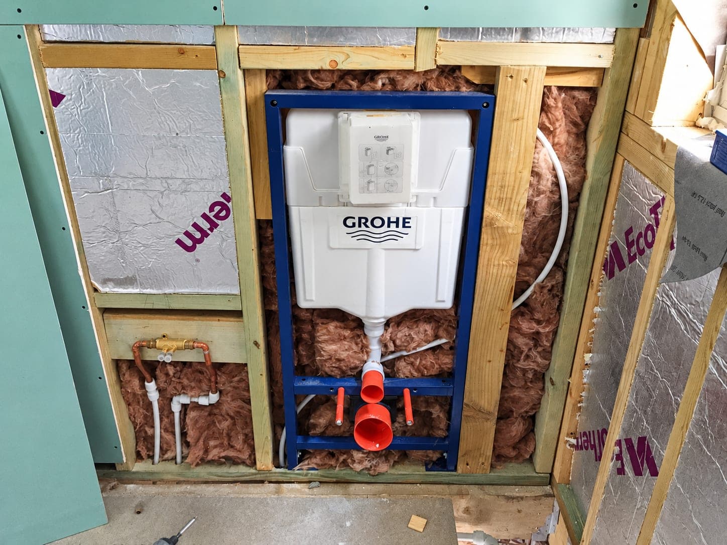 Concealed WC cistern frame set into a stud wall with soil connection, London
