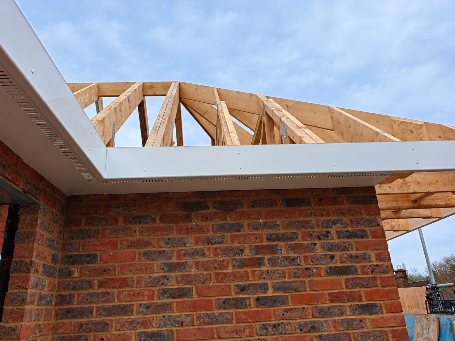 New roof trusses with fascia and soffit fitted to a brick extension, London