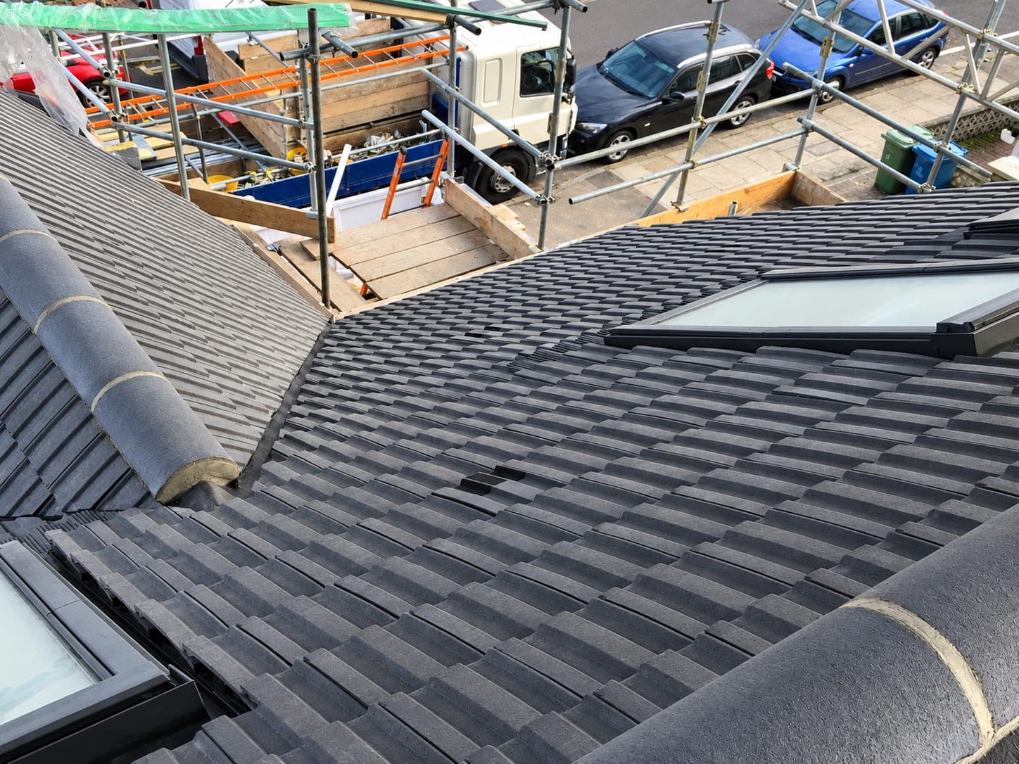 Full roof slope re-tiled with rooflights, scaffold still up, London