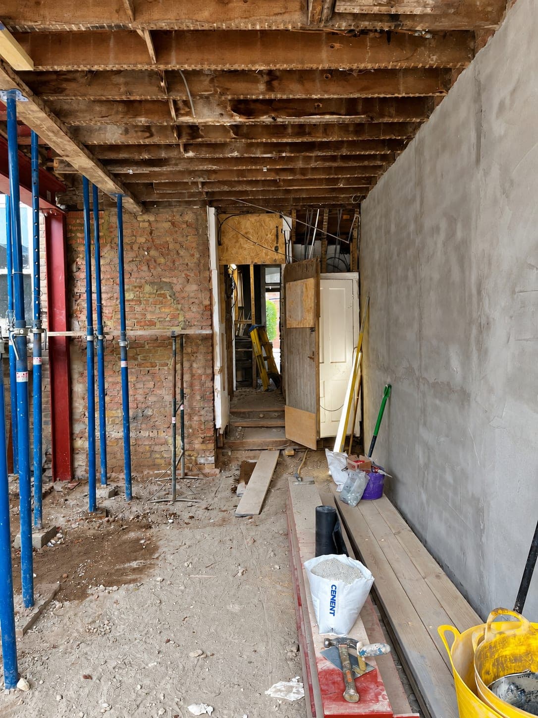 Acrow props holding the ceiling while a new opening is formed, London