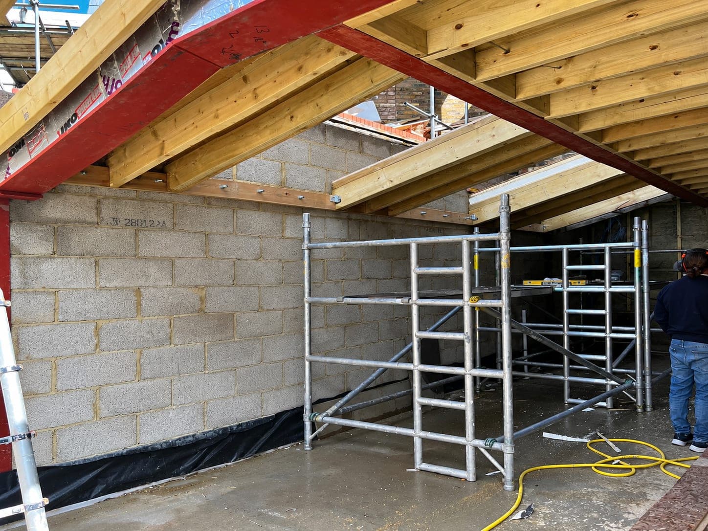 Blockwork built up to meet a new steel beam, London