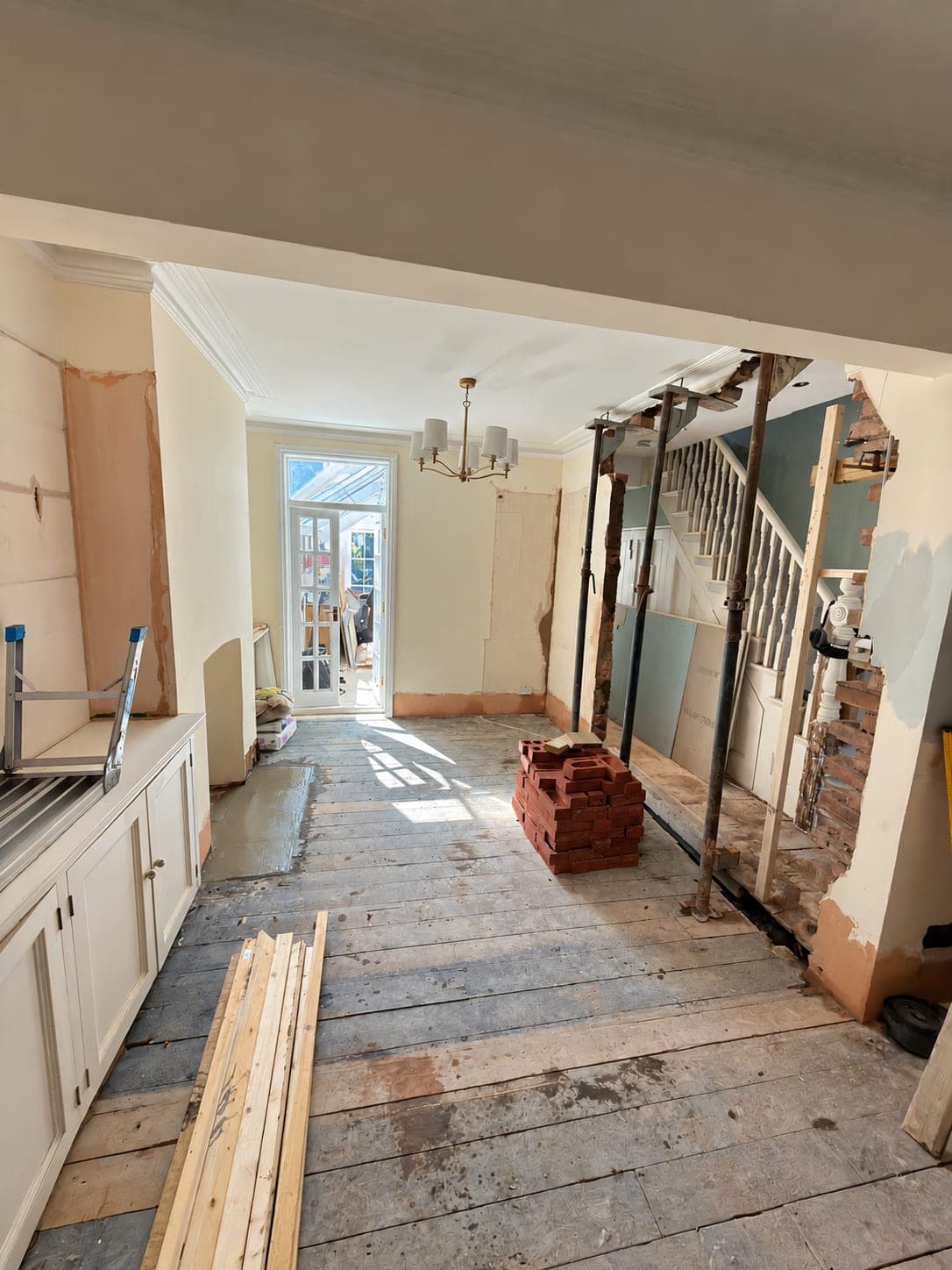 Floorboards lifted back to the joists alongside the kitchen run, London