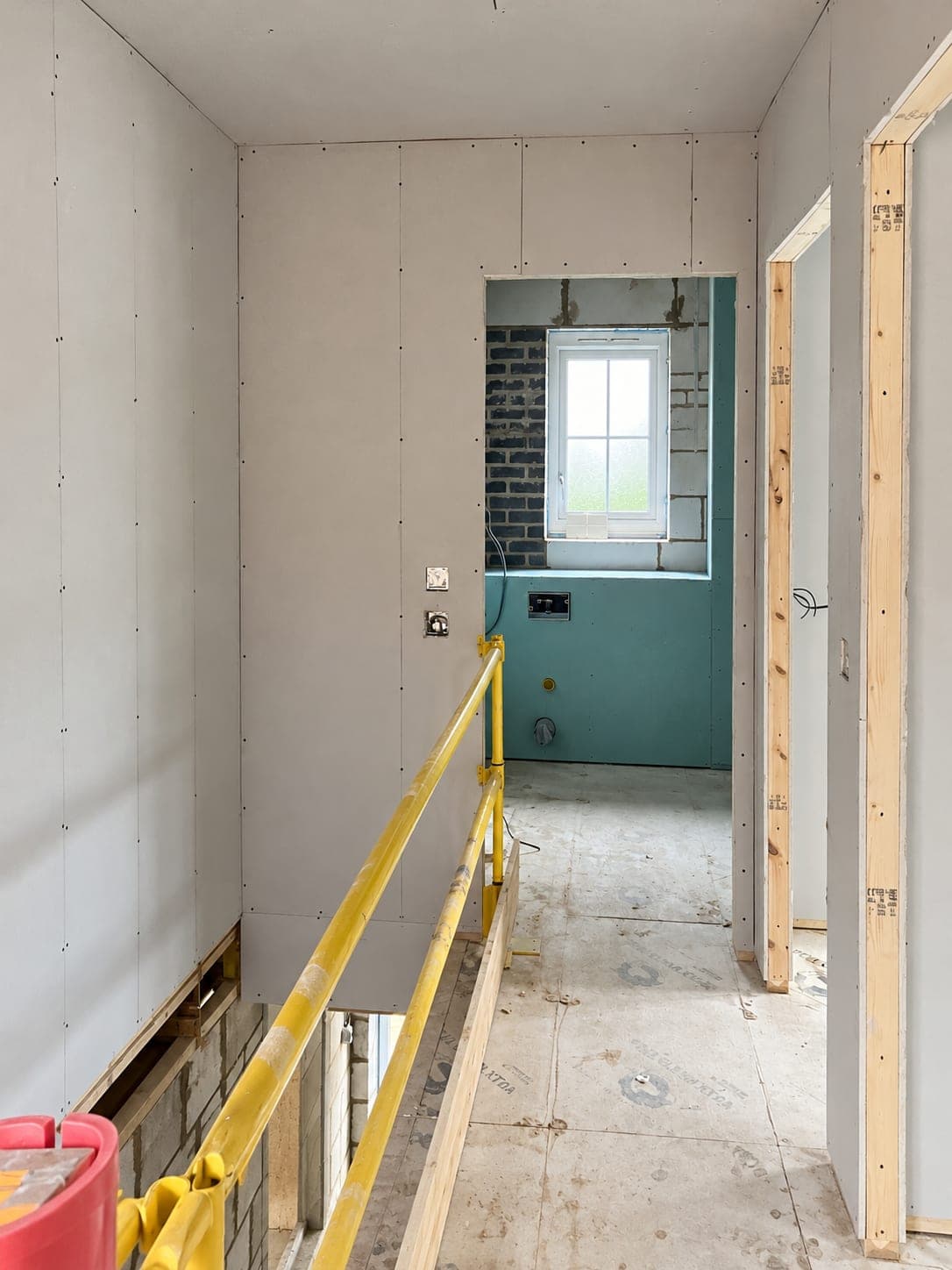 Partitions boarded out forming a corridor through to the next room, London