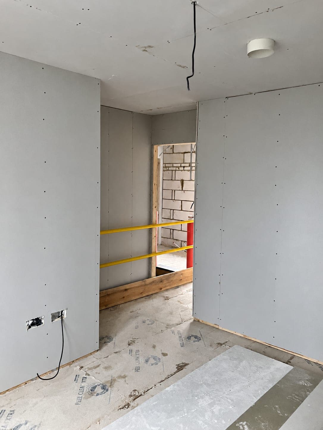 Boarded partition corner ready for taping, London