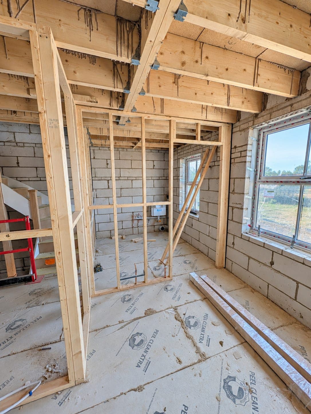 Stud framing built around a window opening, London