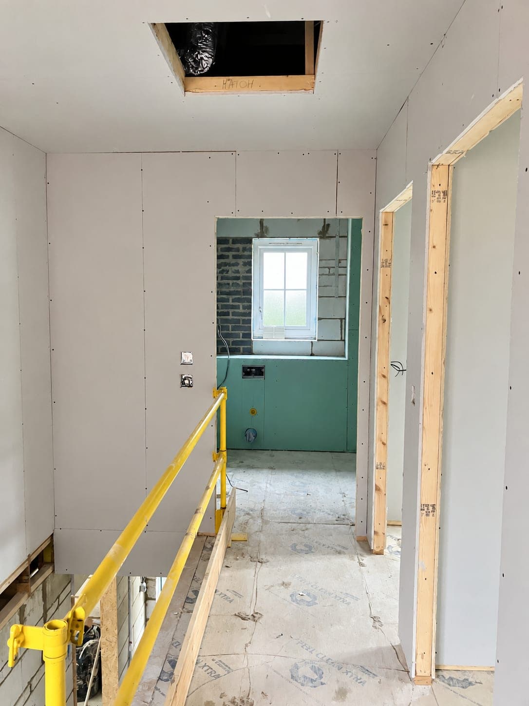 Door opening framed and boarded within a new partition, London