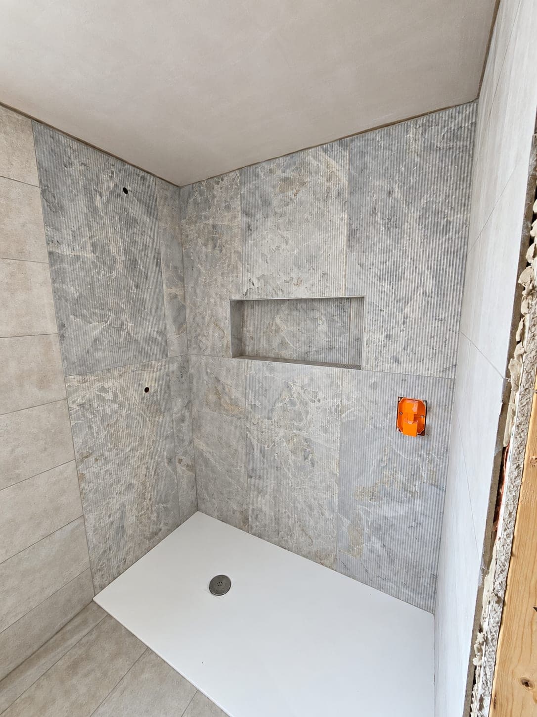 Tiled shower niche with the pattern carried through the surround, London