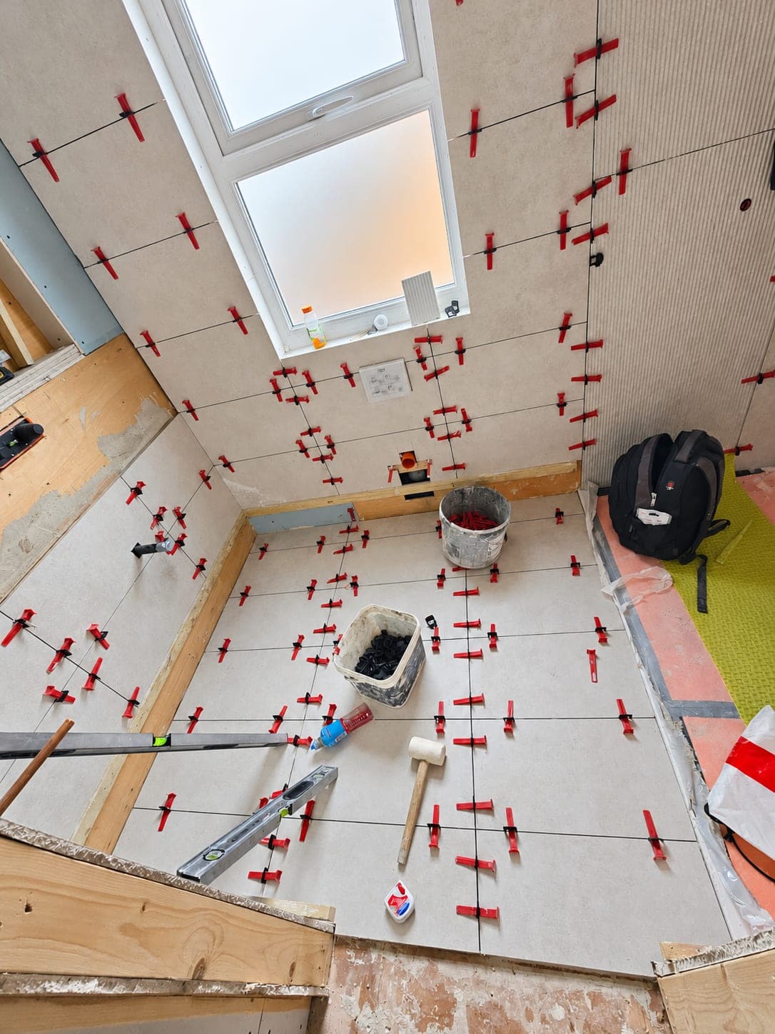 Floor tiles set with levelling clips to keep the surface flat, London