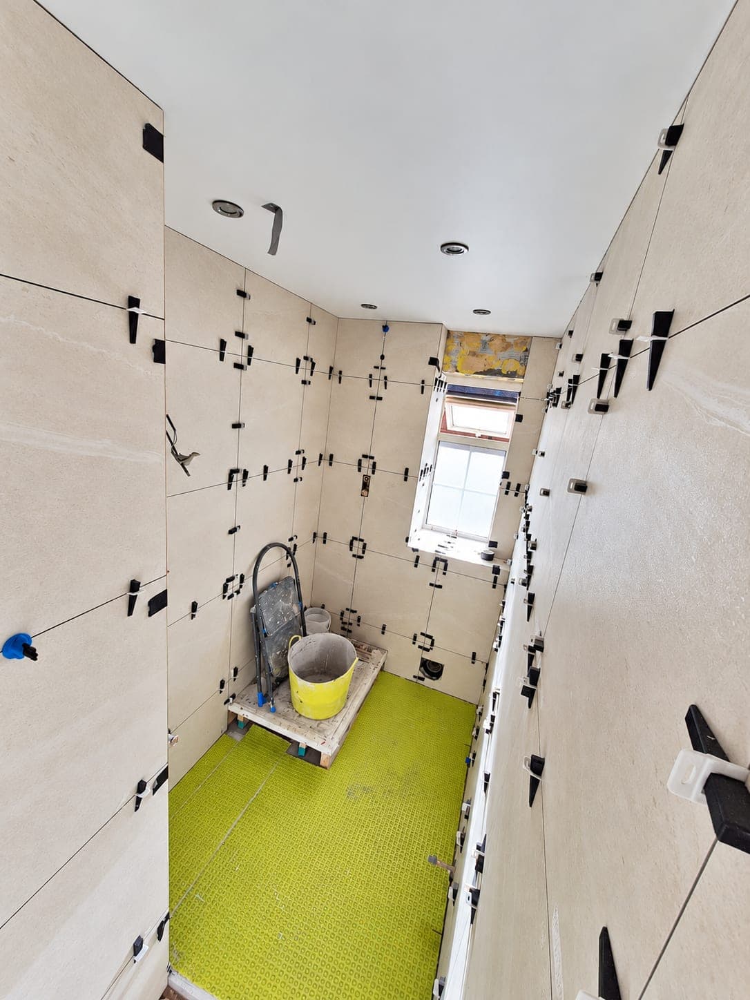 Wall tiles set with levelling clips and spacers during tiling, London