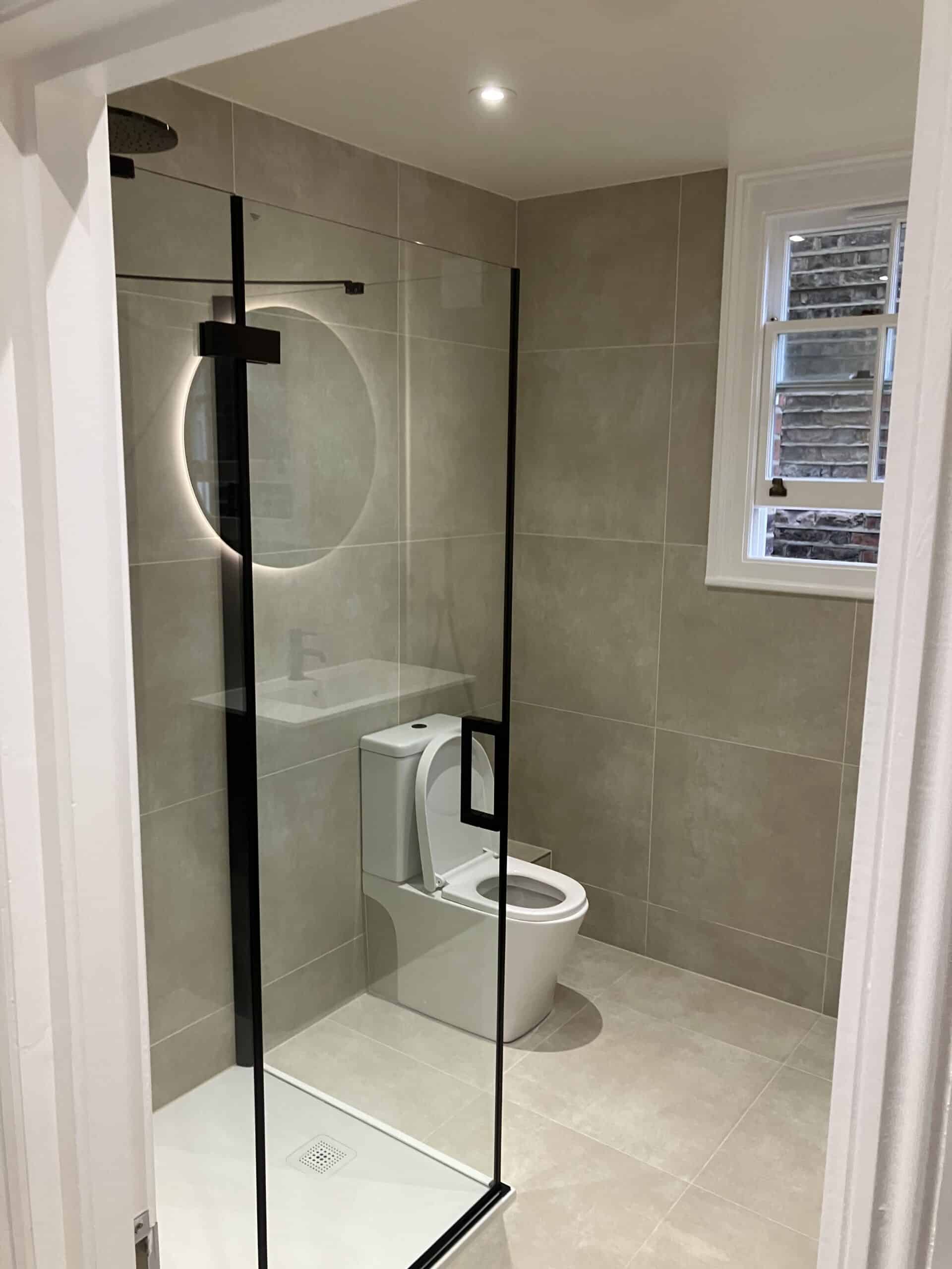 Bathroom refurbishment in London with walk-in shower, wall-hung WC and porcelain floor tiles