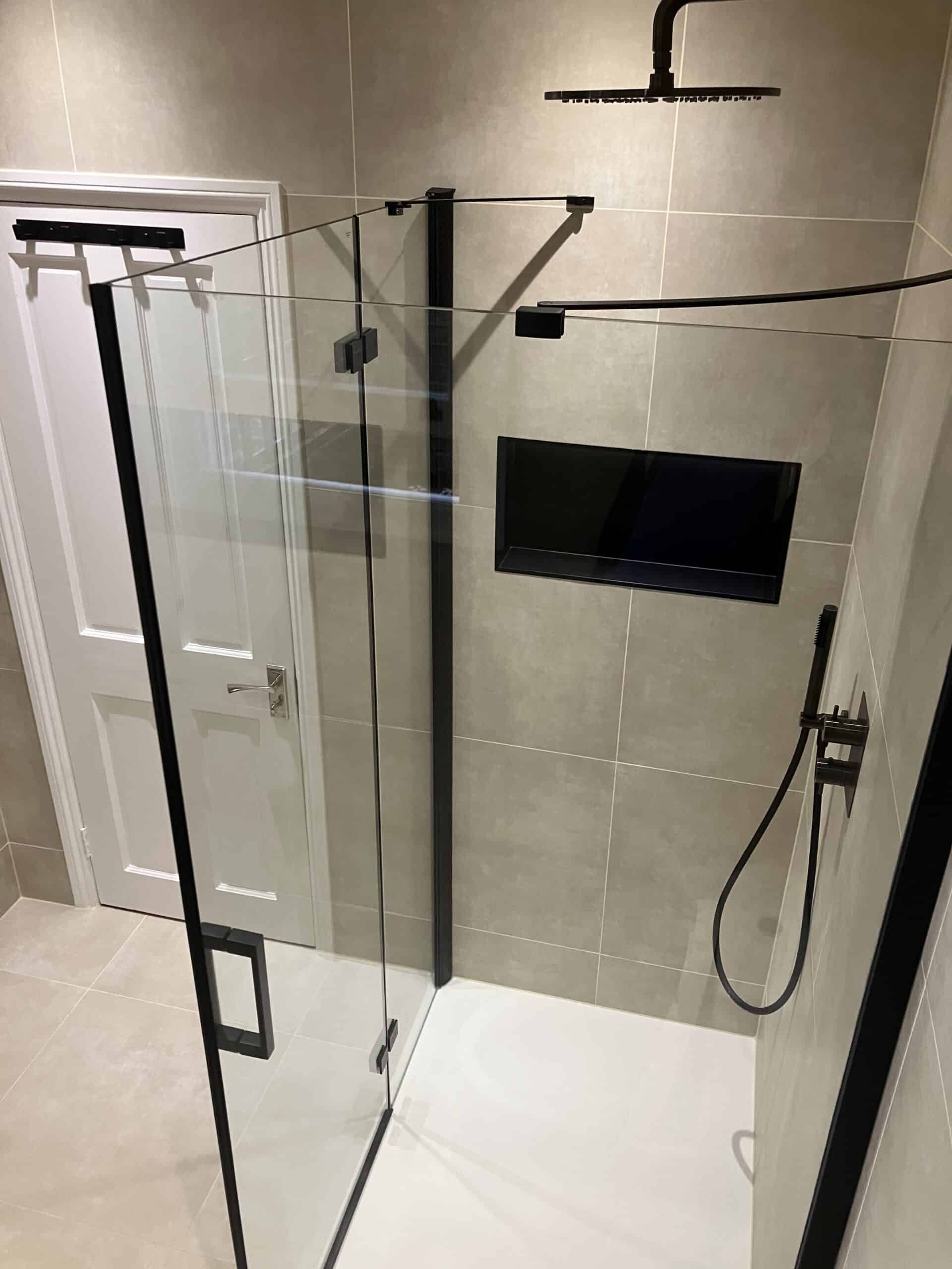 Bathroom renovation in London with recessed shower niche, rainfall shower and matte black fittings